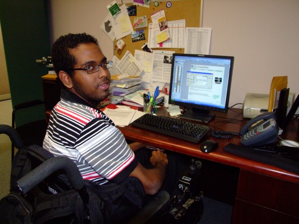 Man in wheelchair working at desk