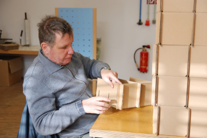 A man with an intellectual disability completing a wood project in a workshop